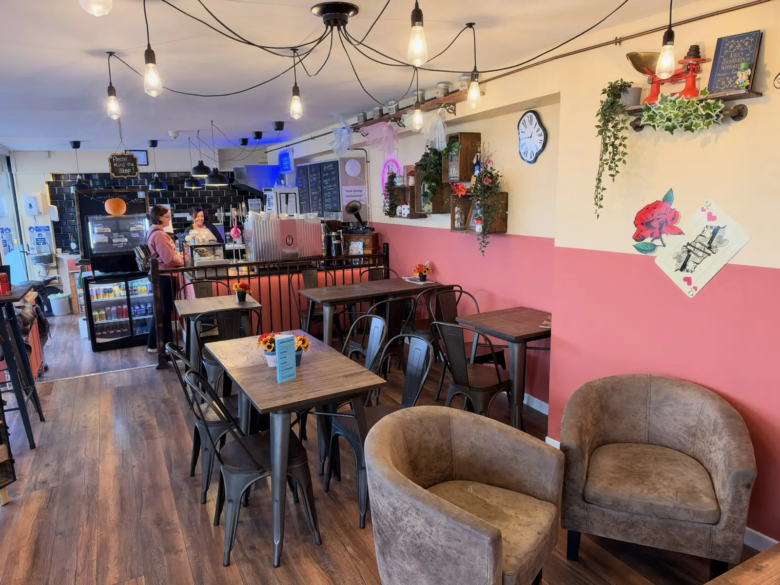 The café's long room with tables, armchairs and festoon lights