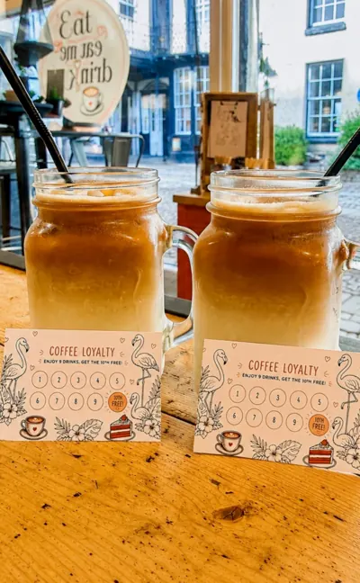 Two iced coffees next to a loyalty card