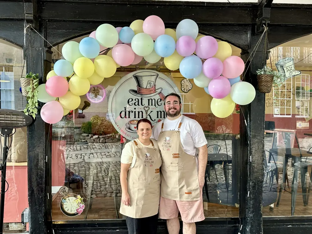 Kat and Ryan under the balloon arch on opening day