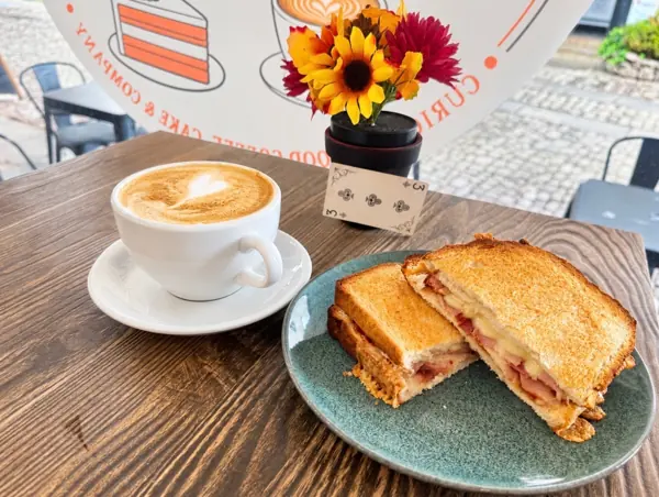 A golden toastie and a latte on our courtyard table